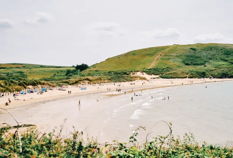 Daymer Bay with swimmers and sunbathers.
