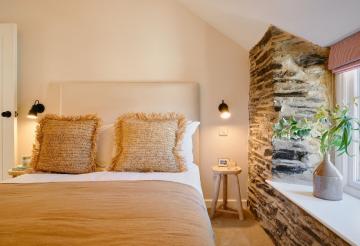 Smaller bedroom with seagrass cushions on the bed.