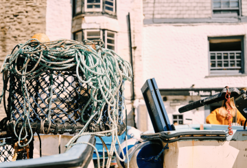 Fishing nets and lobster pots against a white wall