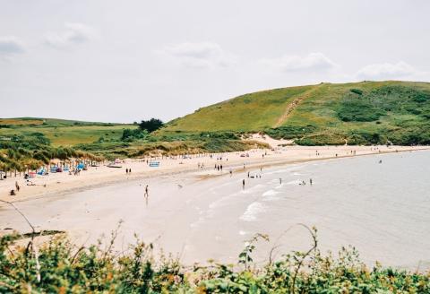 Daymer Bay with swimmers and sunbathers.