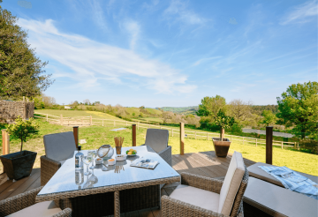 An elevated balcony that looks out across rolling fields and countryside
