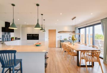 Four Geese's open plan kitchen and dining room, with sliding doors to the right.