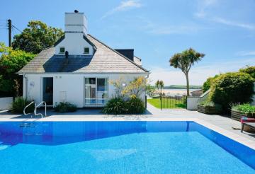 Trehayl's outdoor swimming pool with views over Rock.