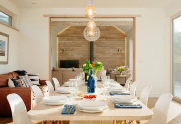 A dining table with a pendent light above it